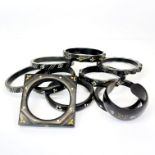 A collection of yellow and white metal inset cattle horn jewellery, largest 8.2cm.