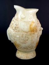 A Chinese carved jade archaic form fish shaped vase, H. 25cm.