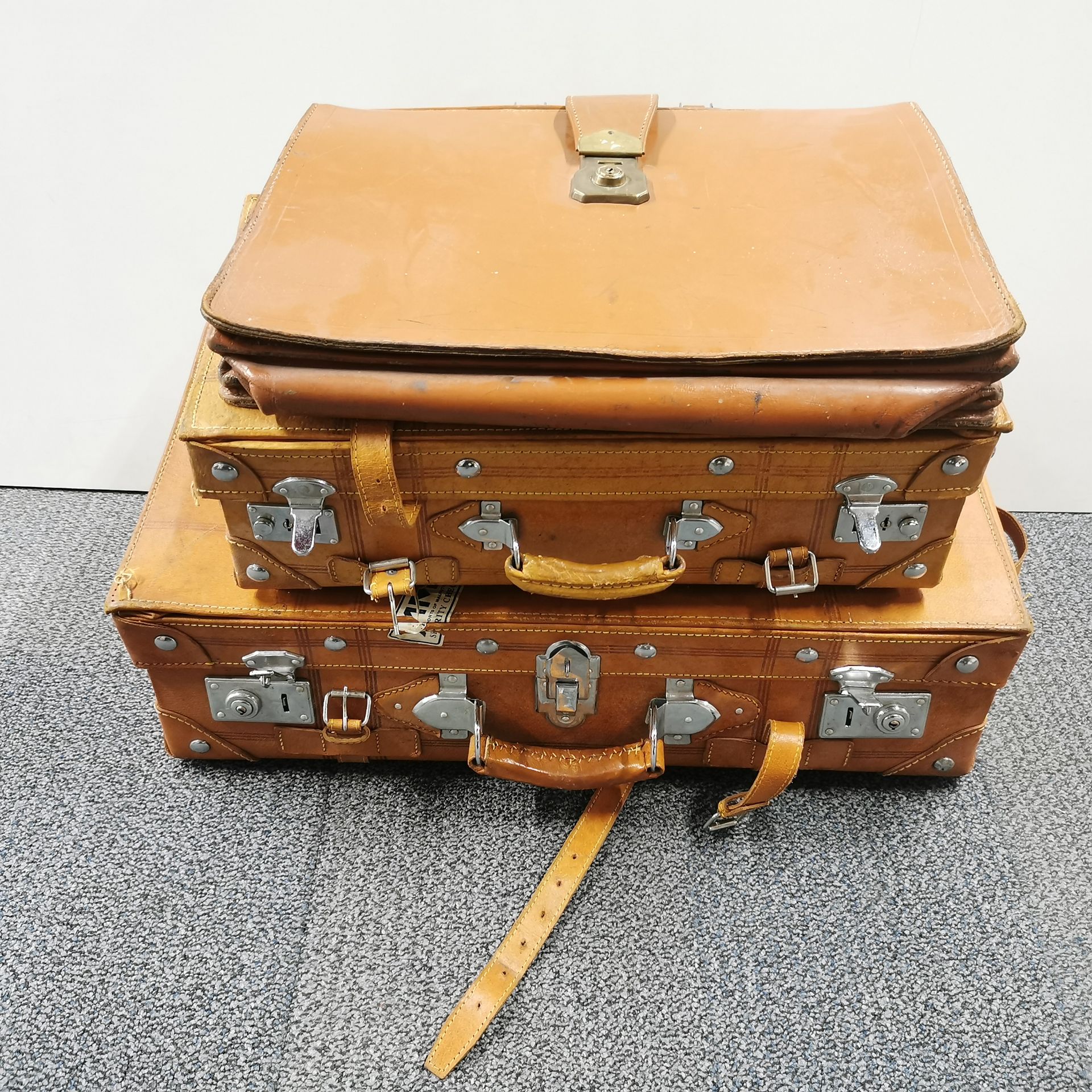 Three good leather cases, largest 62 x 34 x 18cm.