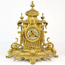 A 19th C. gilt brass mantle clock with porcelain numerals, H. 39cm.