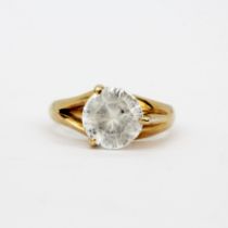 A yellow metal (tested minimum 14ct gold) ring set with a round cut white stone, (Q).