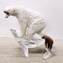 A ceramic figure of a polar bear on a crystal iceberg base, H. 28cm. Together with a further bear on