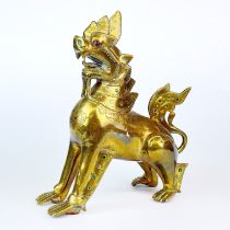 A 19th/20th C. Burmese stone inset brass temple lion, H. 19cm.