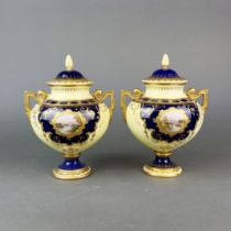 A pair of Coalport fine hand painted jars and covers, H.23cm. A/F
