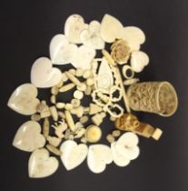 A collection of antique carved bone jewellery and other items.
