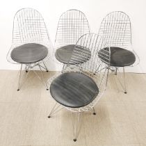A set of four chrome wirework chairs with circular vinyl seats, H. 87cm.