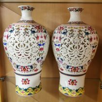 A pair of Chinese pierced porcelain hand-painted vases with inner rotating separate vase, overall H.