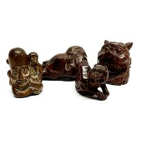 A group of four signed Japanese carved wooden netsuke figures, largest 7cm.