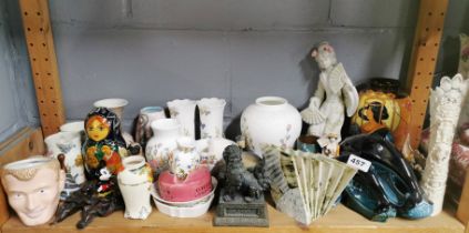 A collection of mixed ceramic and other items.