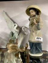 A Lladro figure of a Vietnamese girl with a child on her back, H. 27cm. Together with a Nao figure