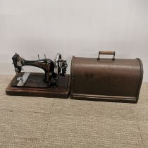 A cased Singer sewing machine.