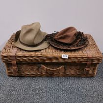A vintage picnic hamper, 64 x 34 x 20cm. Together with two vintage hats.