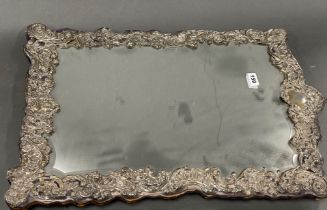 An impressive antique hallmarked silver faced mirror, H. 66cm.