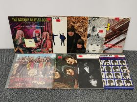 A group of nine Beatles albums.