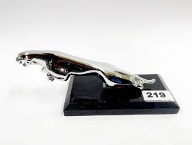 A chromium plated Jaguar mascot style figure on a marble base, L. 21cm.