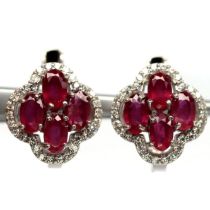 A pair of 925 silver earrings set with oval cut rubies and white stones, L. 1.3cm.