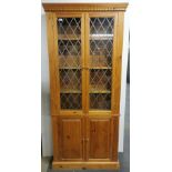 A pine display cabinet with two cupboard doors underneath, 200 x 84 x 20cm.