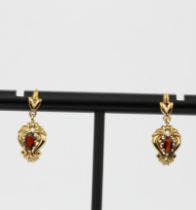 A pair of hallmarked 9ct yellow gold drop earrings set with an oval cut garnet, L. 1.7cm.