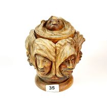 A 19th C. carved wooden tobacco box with metal liner and rotating base, H. 20cm. Dia. 16cm.