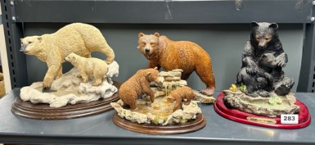 A group of four resin figures of bears, tallest 23cm.