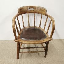 An oak bar back elbow chair with leather seat, H. 74cm.