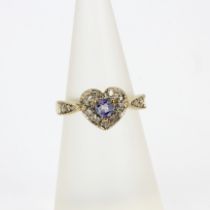 A 9ct yellow gold heart shaped ring set with a tanzanite and diamonds, (K.5).