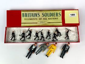 A boxed set of British soldiers with a group of Star Wars figures.