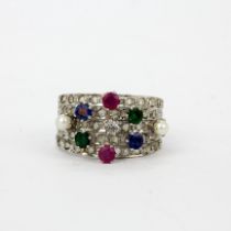 An 18ct white gold multi row ring set with diamonds, rubies, emeralds and seed pearls, (P). One