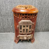 An antique French brown enamelled wood burning stove, 65 x 40 x 30cm.