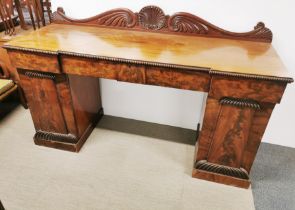 An impressive four drawer mahogany buffet sideboard with carved decoration and flamed mahogany