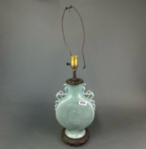 An early 20th C. Chinese incised celadon glazed porcelain vase mounted as a lamp base, H. 45cm.