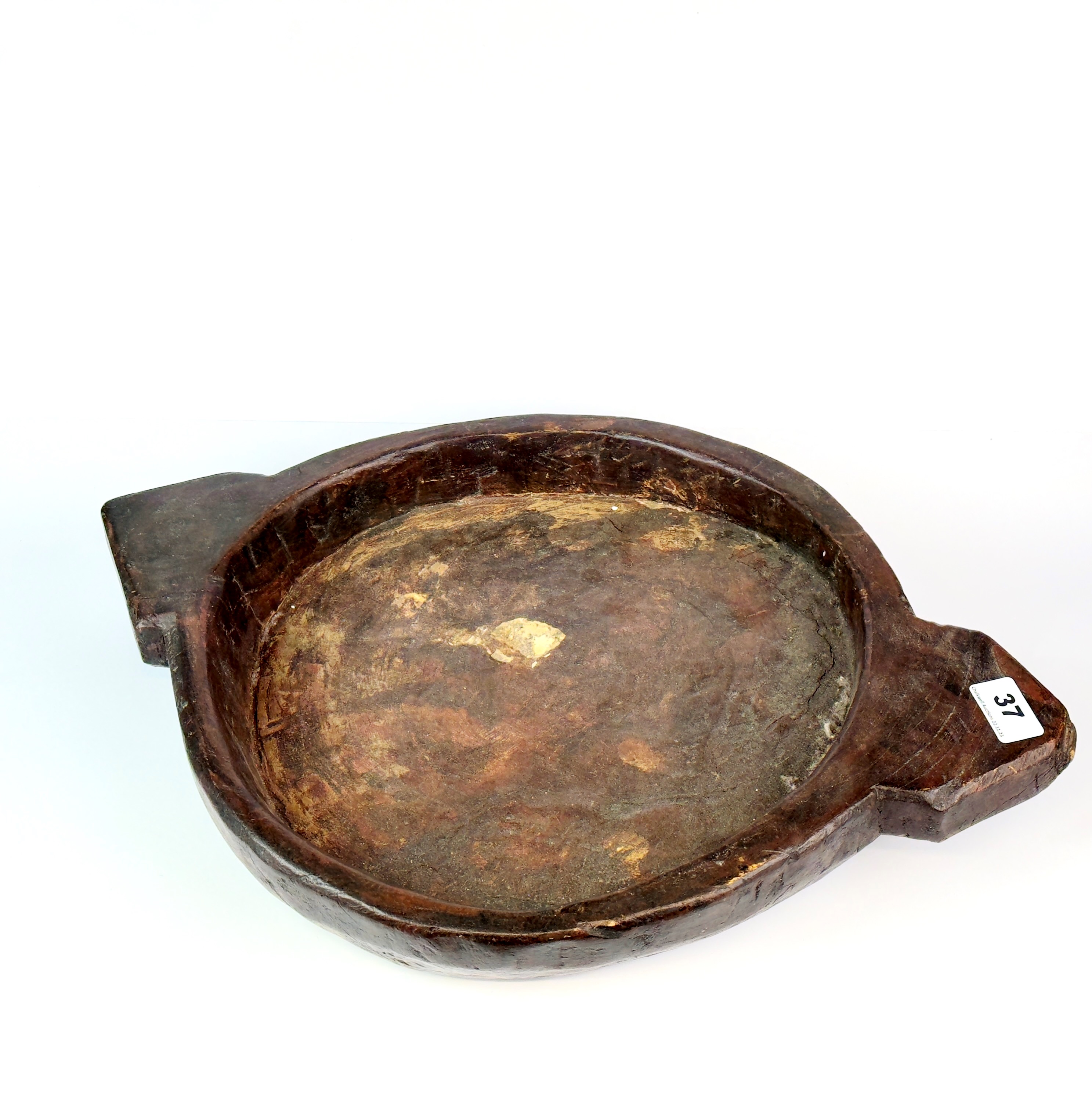 An Eastern antique carved wooden platter, W. 51cm. - Image 2 of 2