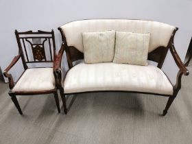 A cream upholstered inlaid mahogany two seater settee together with a matching carver/ hall chair,