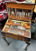 An oak cabinet cased silver plated cutlery set by Mappin and Webb.