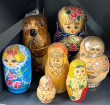 Seven sets of Russian hand-painted wooden nesting dolls, tallest 19cm.