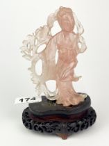 A Chinese carved rose quartz figure of a Tang lady with a carved wooden base, overall H. 17cm. Minor