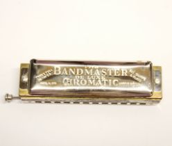 A Bandmaster chromatic harmonica.