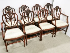 A set of eight carved mahogany and beige upholstered dining chairs comprising of two carvers and six