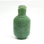 A Chinese carved serpentine snuff bottle, H. 10cm.