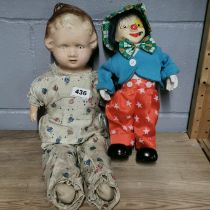 A vintage mechanical clown with a composition child doll, clown H. 32cm.