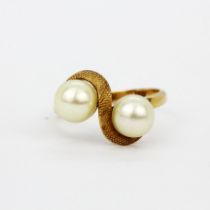 An 18ct yellow gold (marked 18K) ring set with cultured pearls, (P).