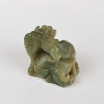 A Chinese carved jade figure of a dragon and a baby, H. 5cm.