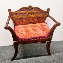 A carved mahogany hall seat with cushion, H. 97cm W. 86cm.