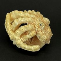 A carved Tagua nut Octopus, H. 3.5cm, L. 4.5cm.