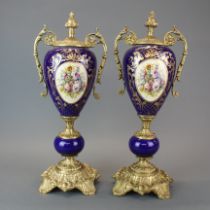 A pair of gilt metal mounted continental porcelain garnitures, H. 46cm.