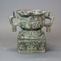 An archaic form Chinese bronze urn/censer, H. 18.5cm, W. 22cm.