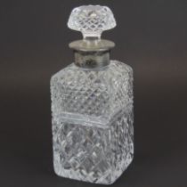 A hallmarked silver and cut crystal decanter.