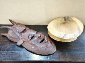 A carved hardwood tribal mask, H. 53cm. Together with two rustic wooden bowls.