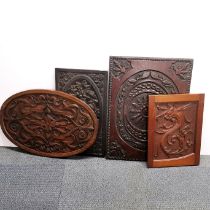 A group of four antique carved wooden panels, largest 50 x 69cm.