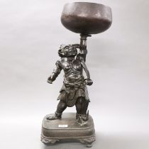 A superb 19th century Japanese bronze singing/offering bowl held aloft by a guardian deity, H. 61cm.